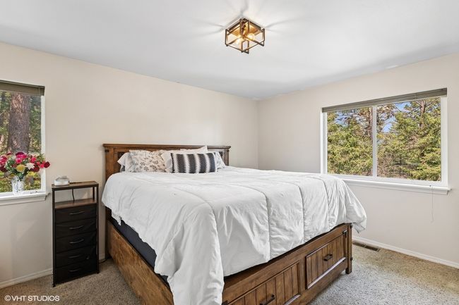 Bedroom with light colored carpet and baseboards | Image 16