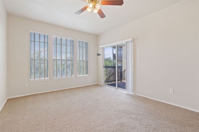 Spare room with baseboards, ceiling fan, and carpet flooring | Image 8