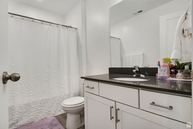 Bathroom with vanity, toilet, and wood finished floors | Image 11