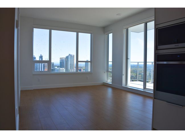Spare room featuring baseboards and wood finished floors | Image 10