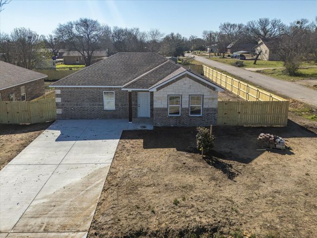 Ranch-style home with fence, brick siding, a residential view, and a shingled roof | Image 5
