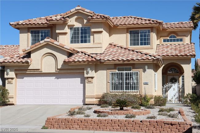 Mediterranean / spanish-style home featuring concrete driveway, a tiled roof, and stucco siding | Image 4