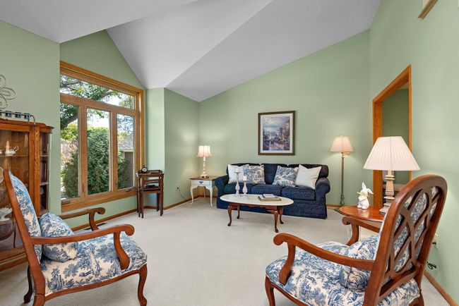 Main level living room with vaulted ceiling. | Image 6