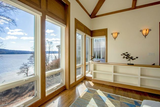 Sunroom / solarium with a water view and lofted ceiling | Image 23