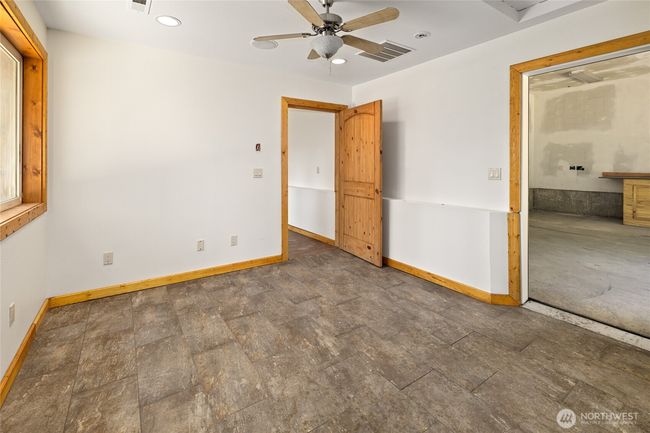 Additional finished room downstairs off the garage. | Image 15