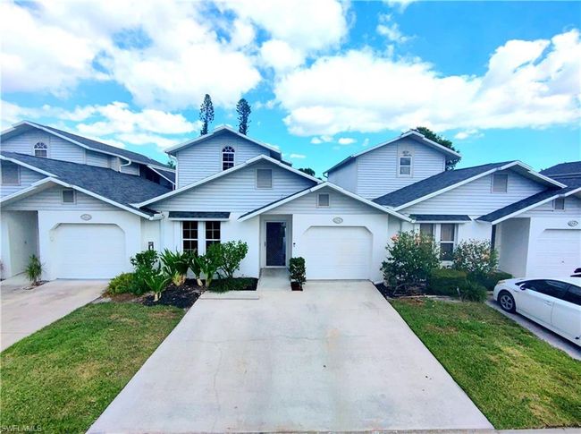 View of front of property featuring driveway, a front yard, and a garage | Image 35