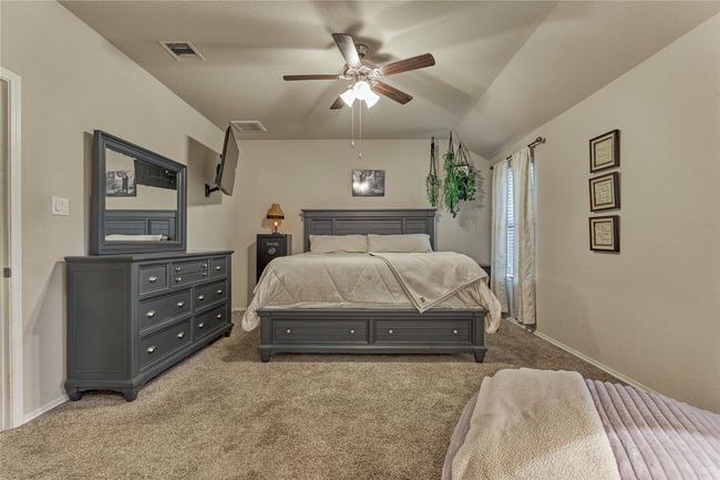 Light and bright primary bedroom with ceiling fan, ensuite and walk-in closet. f | Image 26