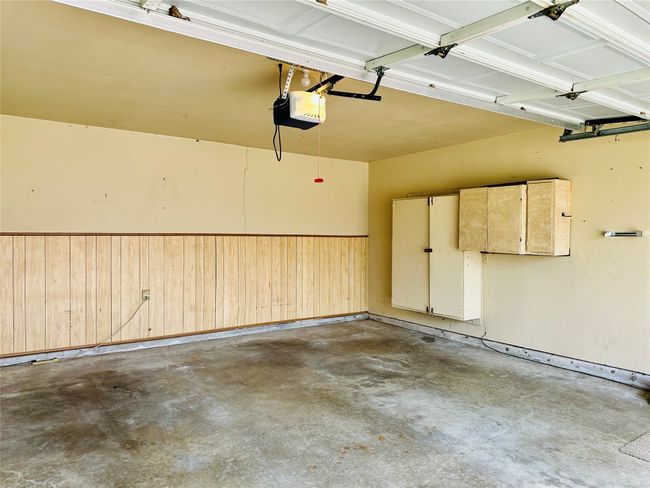 Garage with wooden walls, a garage door opener, and wainscoting | Image 15