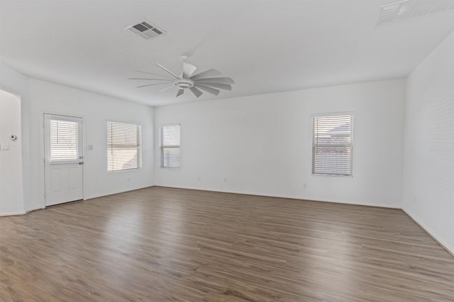 Spare room with a ceiling fan, a healthy amount of sunlight, and visible vents | Image 10
