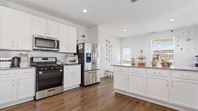 Kitchen has gas cooktop. Stainless steel appliances all included in sale | Image 11