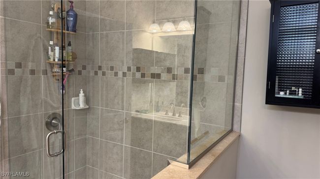 Bathroom with a tile shower | Image 8