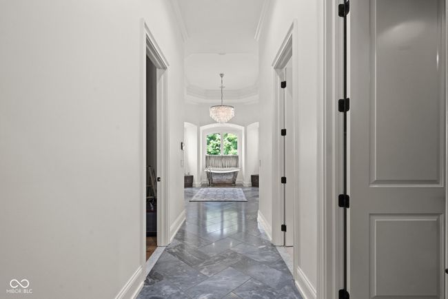 hall in primary suit leading to closets and primary bathroom | Image 26