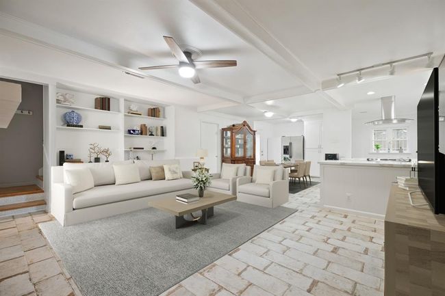 This home has been revitalized with a semi-open concept with seamless access to the kitchen and dining spaces. | Image 7