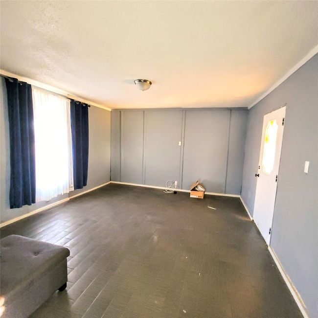 Unfurnished living room with baseboards | Image 5