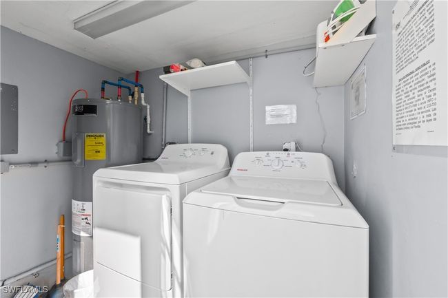 Washroom featuring washing machine and dryer and electric water heater | Image 41