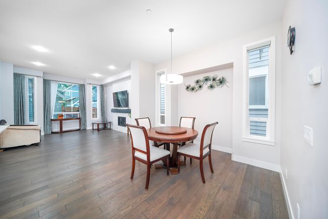 Dining area featuring baseboards and dark wood-style floors | Image 4