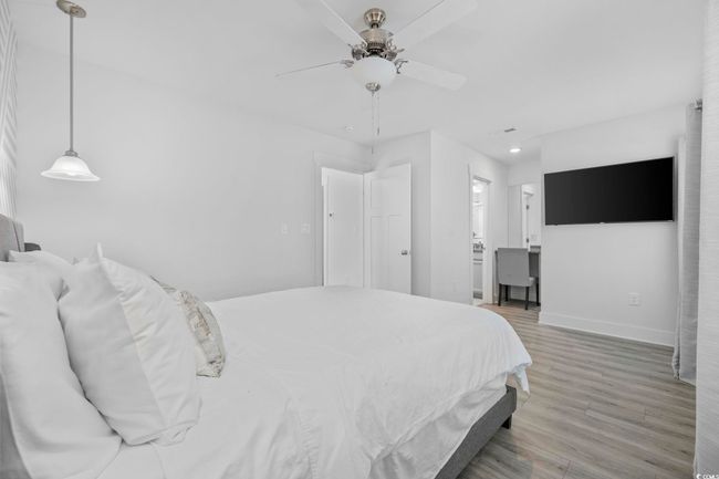 Bedroom featuring recessed lighting, wood finished floors, ensuite bath, baseboards, and ceiling fan | Image 29