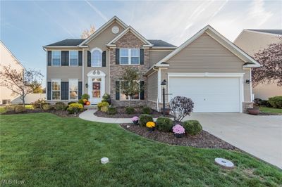 View of front facade featuring a garage and a front lawn | Image 1