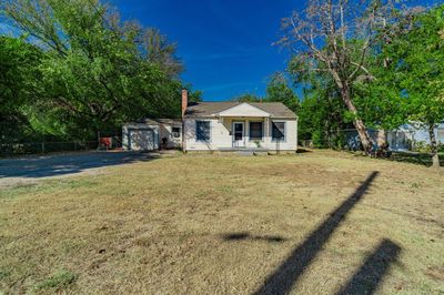 View of front of house featuring a storage unit and a front yard | Image 2