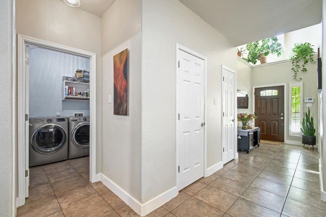 The laundry room is conveniently placed on the main level. | Image 25