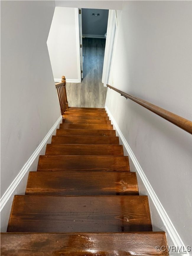Staircase featuring wood finished floors and baseboards | Image 7