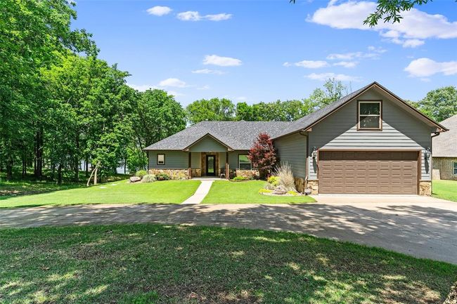 Single story home with a garage and a front yard | Image 1