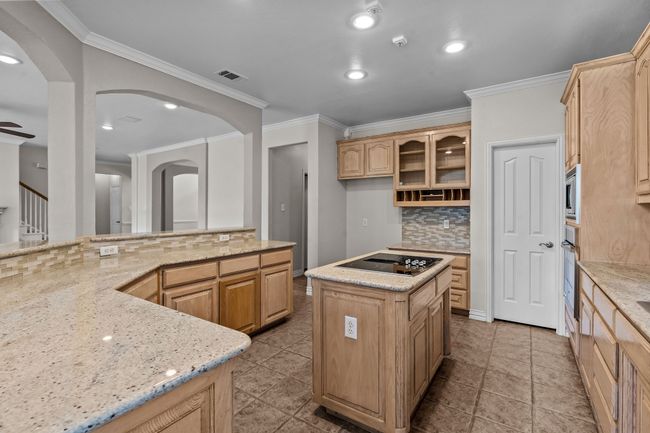 Chef's kitchen featuring stainless appliances, center island, breakfast bar and granite counters | Image 13