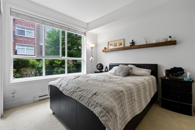 Bedroom featuring light carpet and baseboard heating | Image 29