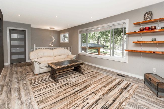 Living area with wood finished floors, baseboards, and recessed lighting | Image 6