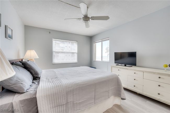 Bedroom featuring ceiling fan, a textured ceiling, and light wood-type flooring | Image 25