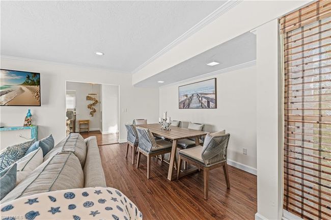 Dining space featuring recessed lighting, wood finished floors, crown molding, baseboards, and a textured ceiling | Image 20