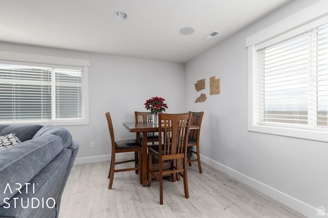 Dining space featuring light wood-type flooring, visible vents, and baseboards | Image 38