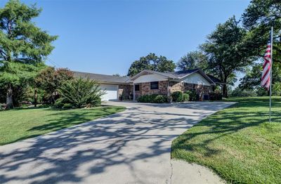 View of front facade with a front yard and a garage | Image 2