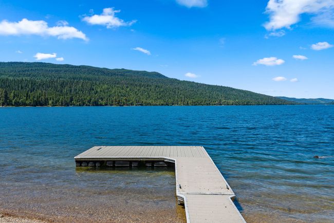 Dock featuring a view of trees and a water and mountain view | Image 28