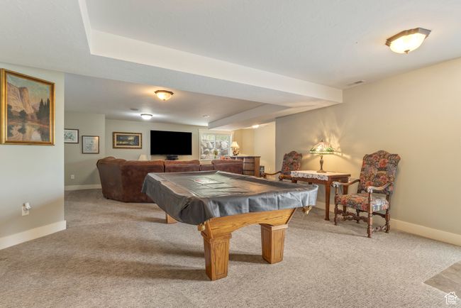 Rec room with light colored carpet, baseboards, and billiards table | Image 27