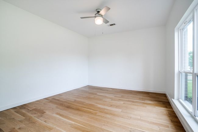 Spare room featuring healthy amount of natural light, light wood-style floors, and a ceiling fan | Image 21