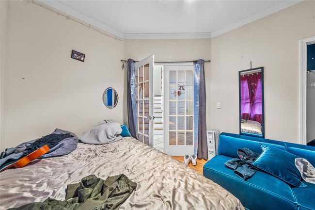 Bedroom with ornamental molding and wood finished floors | Image 30