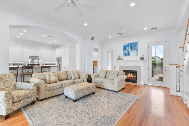 This spacious living room seamlessly connects to the kitchen, perfect for hosting gatherings. | Image 12