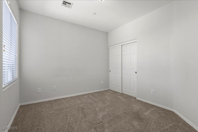 Unfurnished bedroom with carpet floors, multiple windows, and a closet | Image 25