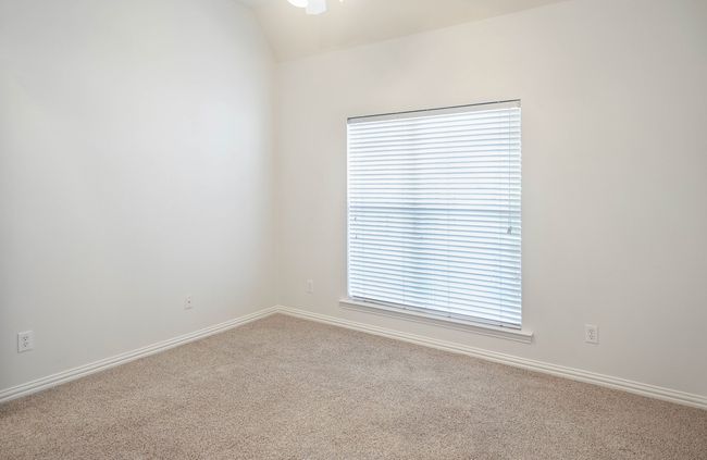 Carpeted empty room with baseboards and vaulted ceiling | Image 22