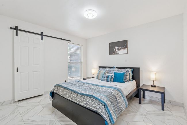 Secondary bedroom with tile flooring, and barndoor for the walk-in closet door! | Image 19