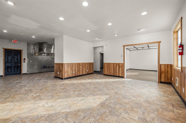 Empty room featuring wainscoting, wood walls, recessed lighting, and stone finish floors | Image 58