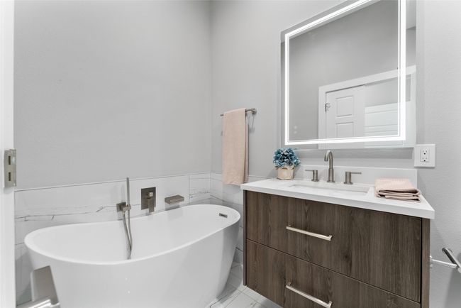 Full bathroom featuring a freestanding bath and vanity | Image 14
