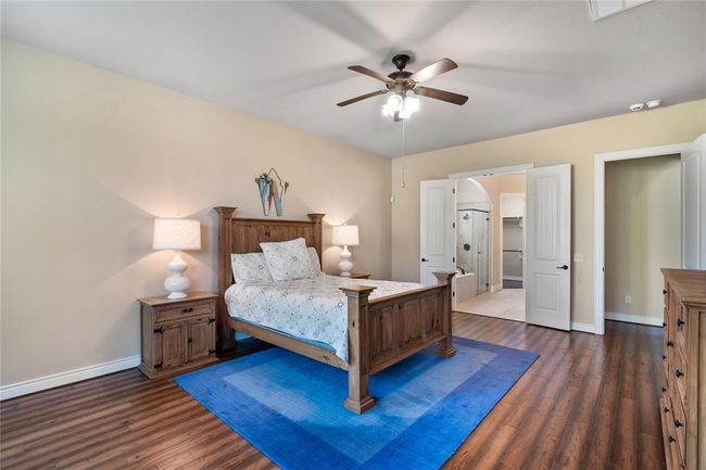 The impressive primary bedroom has an in-suit bathroom. | Image 19