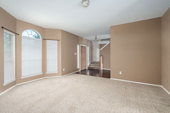 Empty room with dark carpet and stairs | Image 14