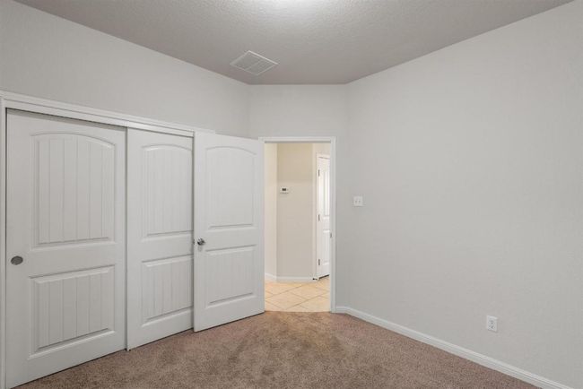 Another view of secondary bedroom #2 with closet. and a textured ceiling | Image 31