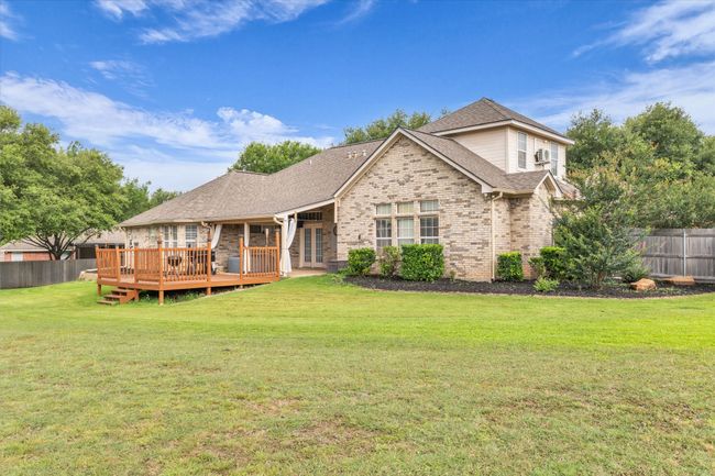 Rear view of property featuring a deck, french doors, brick siding, and roof with shingles | Image 30