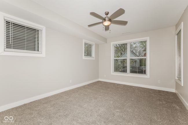 empty room with carpet, a ceiling fan, and baseboards | Image 9