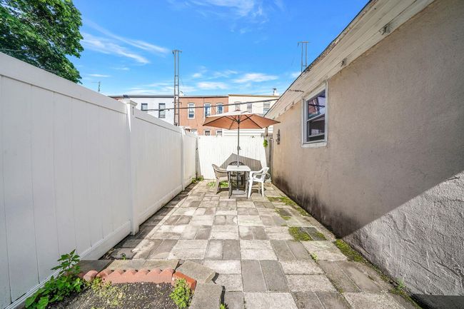 Fenced backyard featuring outdoor dining area and a patio | Image 30
