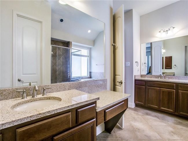 Bathroom with a shower stall, two vanities, and tile patterned floors | Image 14